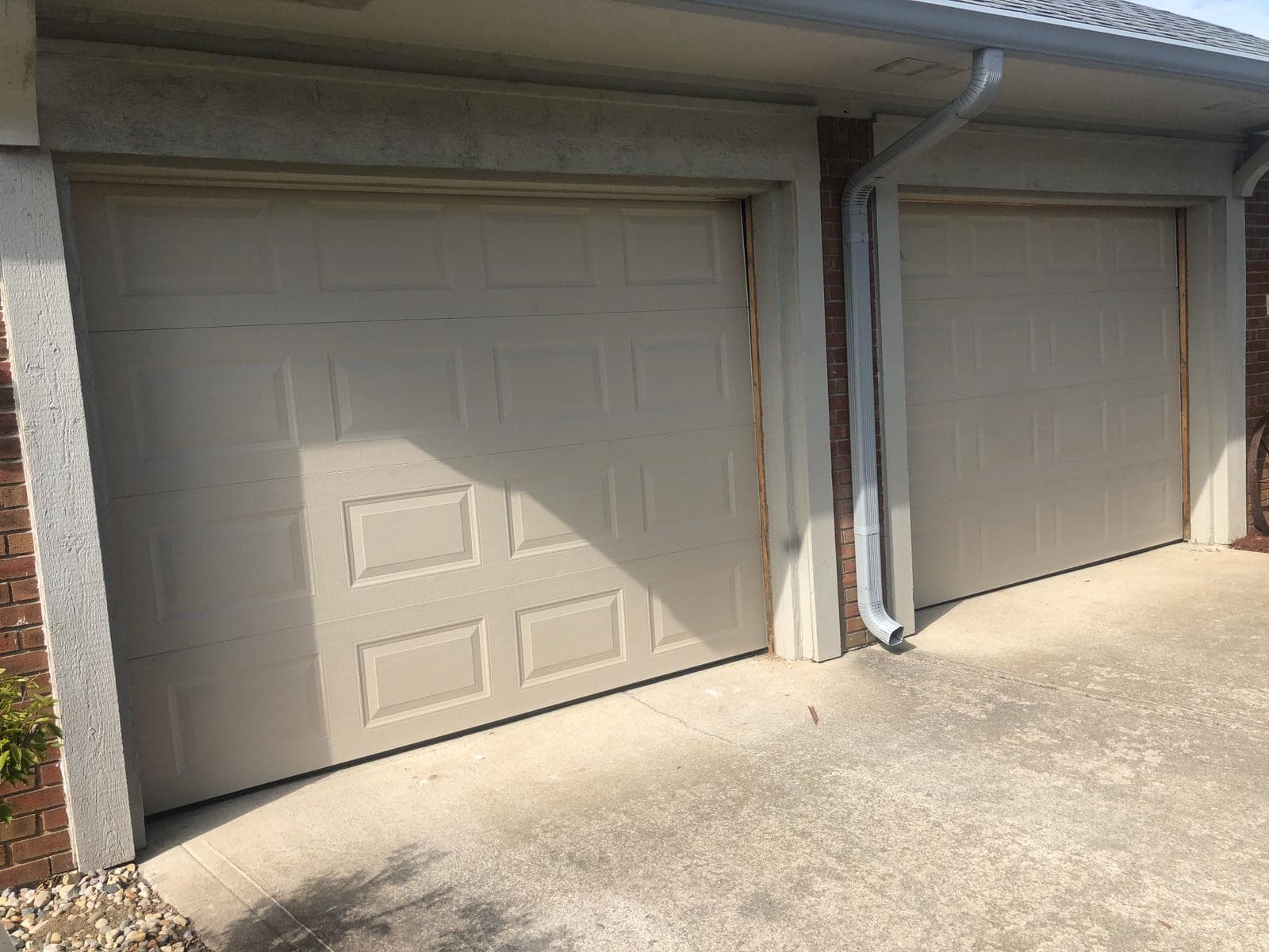 Two new matched insulated garage doors after installation