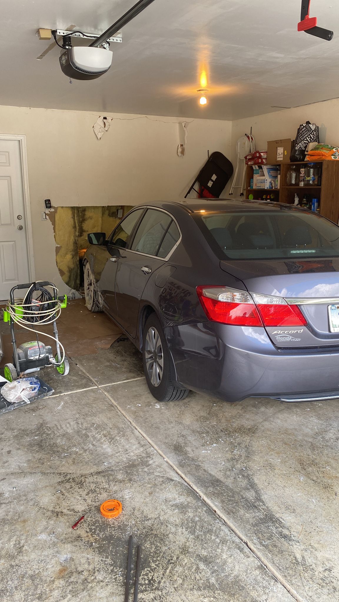 Carmel Customer hit the garage door wall with his car