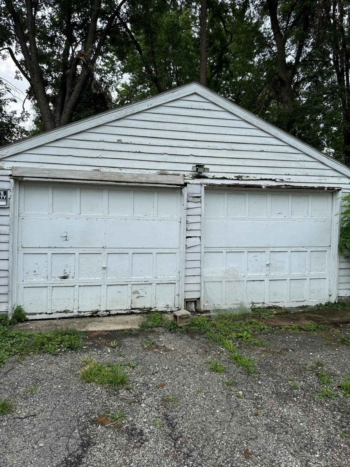 Old worn garage doors before replacement