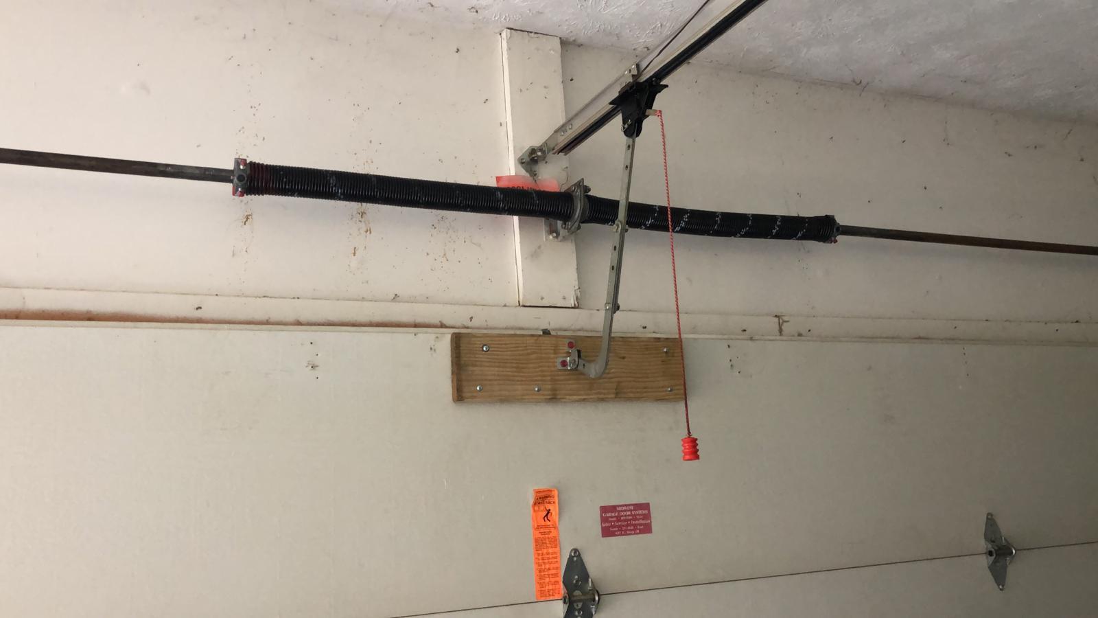 New black coated torsion spring after replacement